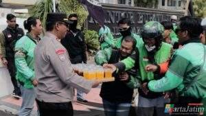 Humanis Polisi Kawal Aksi Damai Driver Ojol di Jember Sambil Berbagi Minuman Dingin